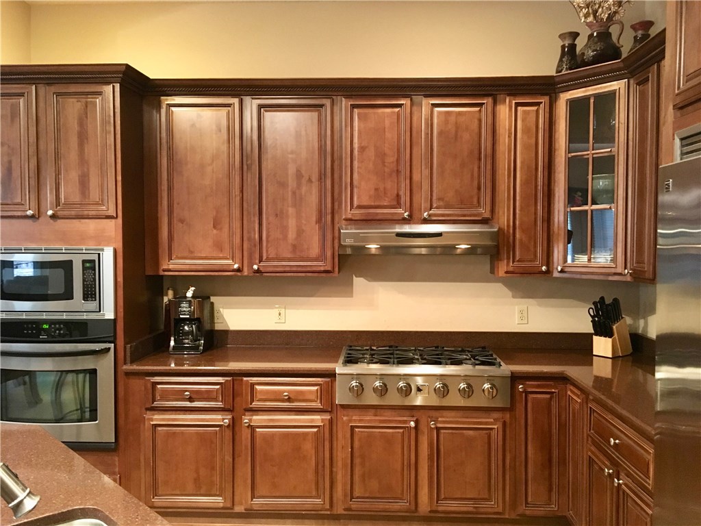 96525 Chester Road Yulee, FL 32097 - Photo 6 of 35 a kitchen with stainless steel appliances granite countertop a stove a sink and a microwave