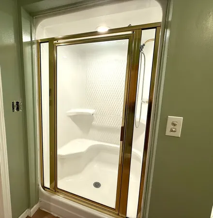a bathroom with a glass shower door