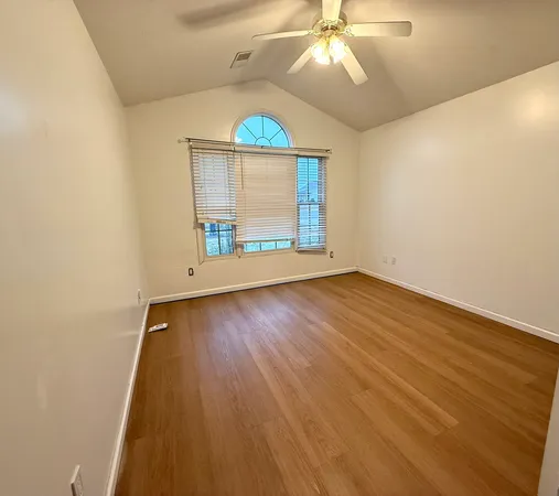 wooden floor in an empty room with a window