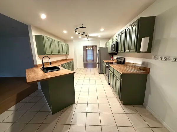 a kitchen with stainless steel appliances granite countertop a sink counter space and cabinets