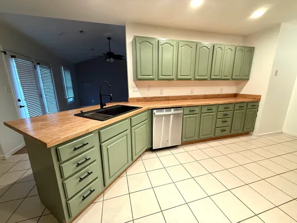 a kitchen with a sink and a refrigerator