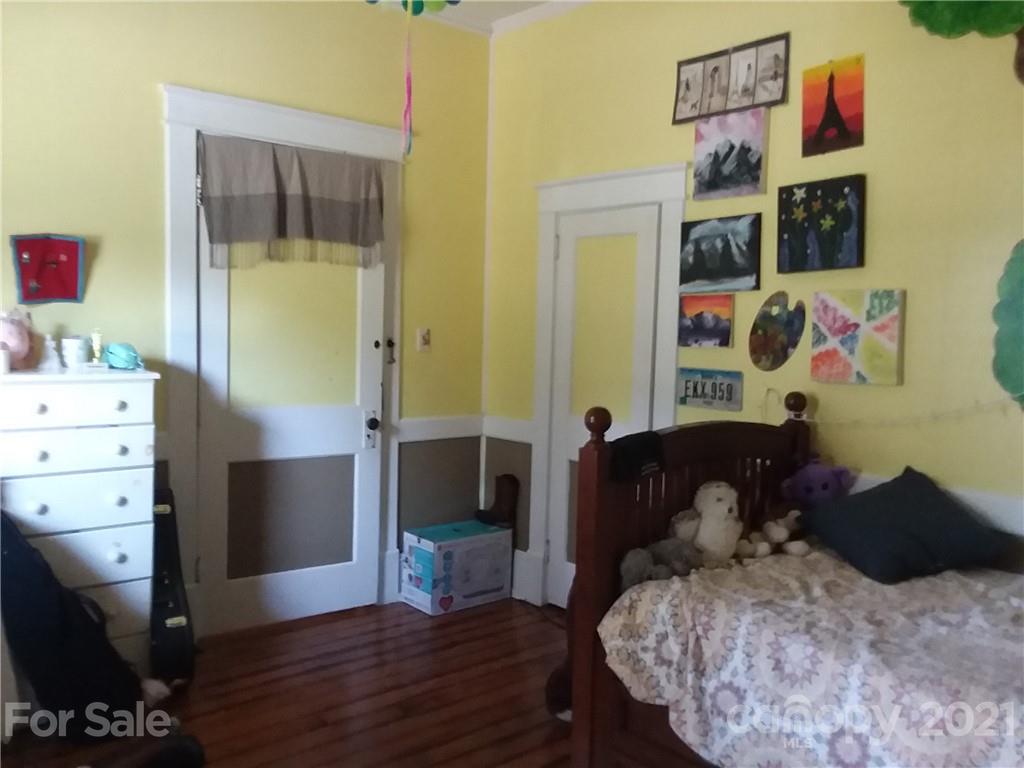 55 Hunter Bridge Road Stony Point, NC 28678 - Photo 14 of 32 a bedroom with a bed and wooden floor