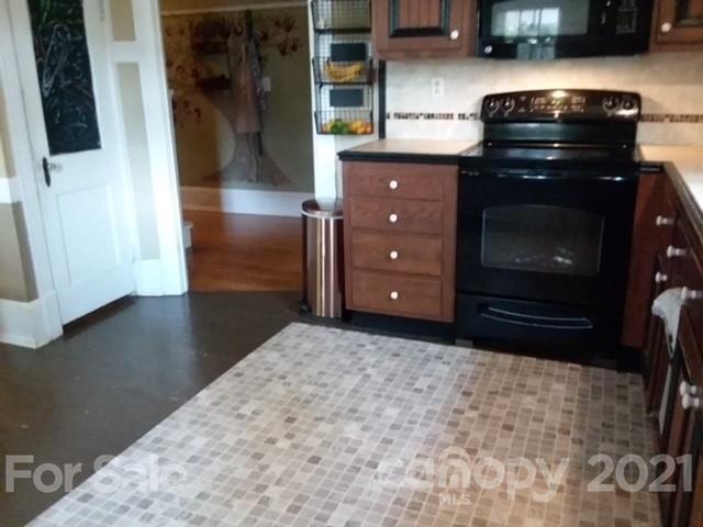 55 Hunter Bridge Road Stony Point, NC 28678 - Photo 22 of 32 a kitchen with granite countertop a stove and a refrigerator
