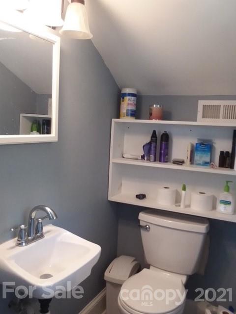 55 Hunter Bridge Road Stony Point, NC 28678 - Photo 26 of 32 a bathroom with a toilet sink and a mirror