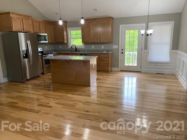 55 Hunter Bridge Road Stony Point, NC 28678 - Photo 28 of 32 a kitchen with stainless steel appliances granite countertop a stove a refrigerator a sink and a microwave