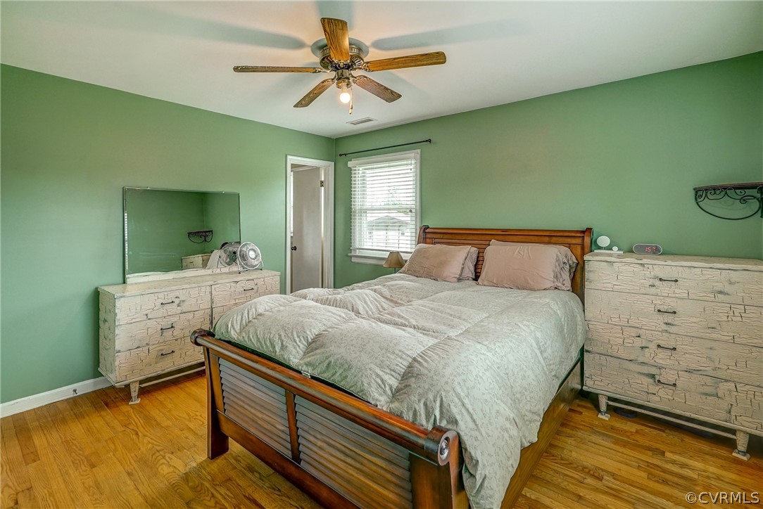 10601 River Road Chesterfield, VA 23838 - Photo 15 of 39 a bedroom with a bed and a chandelier