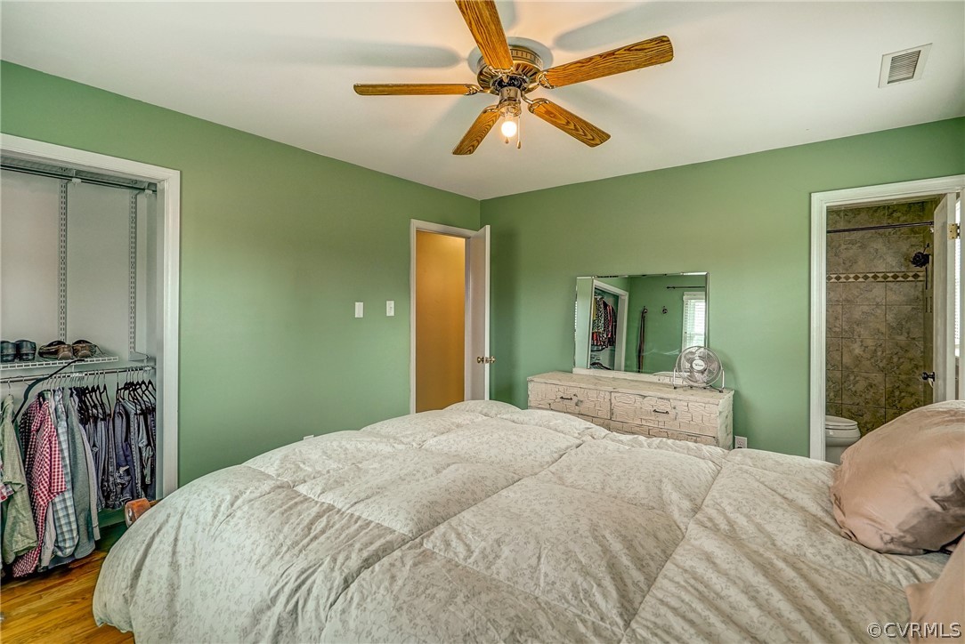 10601 River Road Chesterfield, VA 23838 - Photo 16 of 39 a bedroom with a bed and a chandelier