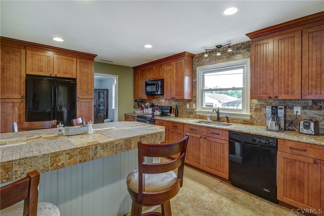 10601 River Road Chesterfield, VA 23838 - Photo 5 of 39 a large kitchen with granite countertop a sink and cabinets