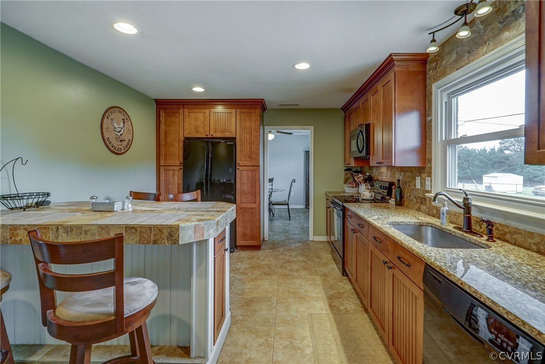 10601 River Road Chesterfield, VA 23838 - Photo 6 of 39 a open kitchen with stainless steel appliances granite countertop a sink a stove and a refrigerator