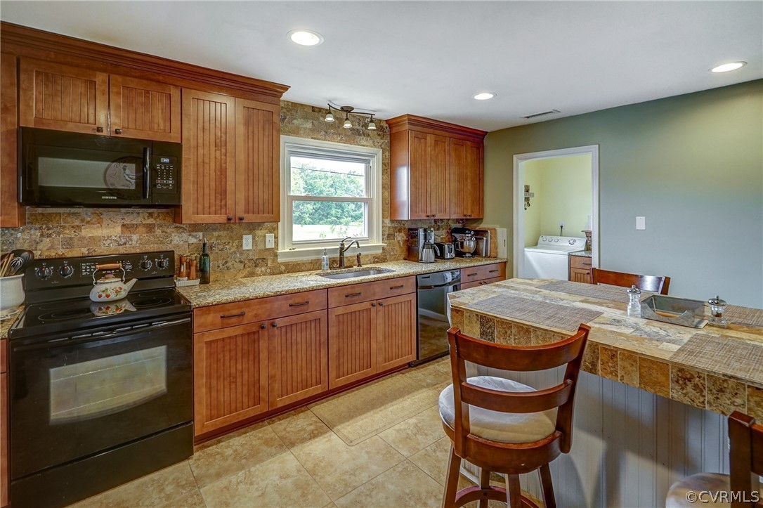 10601 River Road Chesterfield, VA 23838 - Photo 7 of 39 a kitchen with a stove a sink and a microwave