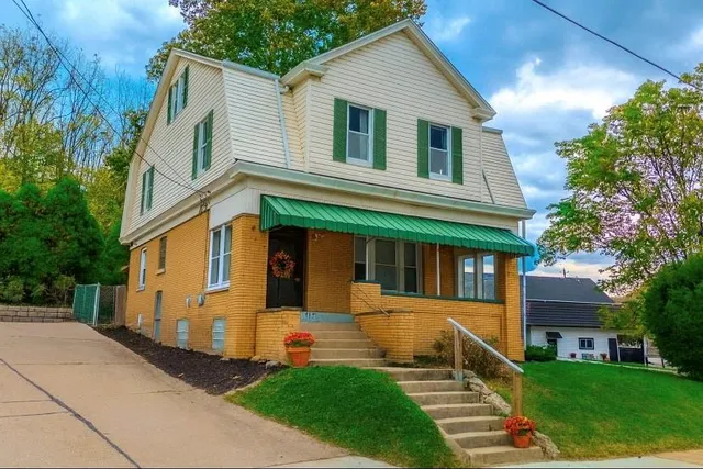 a front view of a house with a yard