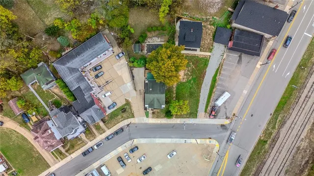 an aerial view of a house with a yard wooden table and chairs