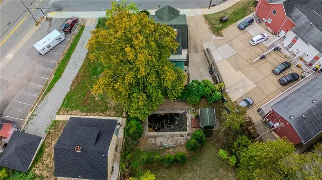 an aerial view of a house with a yard