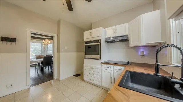 a kitchen with a sink appliances and cabinets