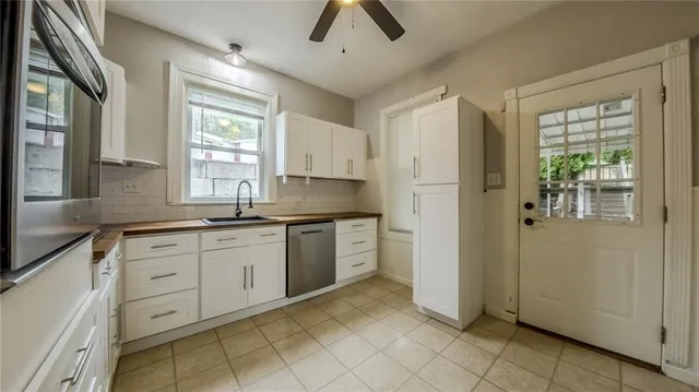 a kitchen with granite countertop white cabinets and white appliances