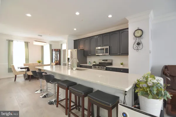 a kitchen with kitchen island a stove a sink and a refrigerator