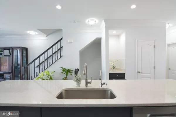 a kitchen with counter top space cabinets stainless steel appliances and wooden floor