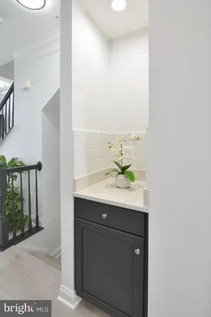 a living room with furniture potted plant and a table