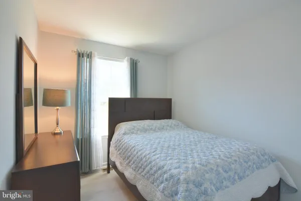 a bedroom with a bed and a television