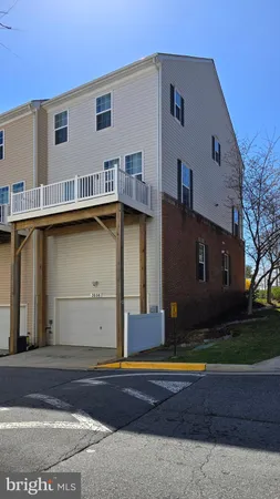 a view of a house with backyard and trees