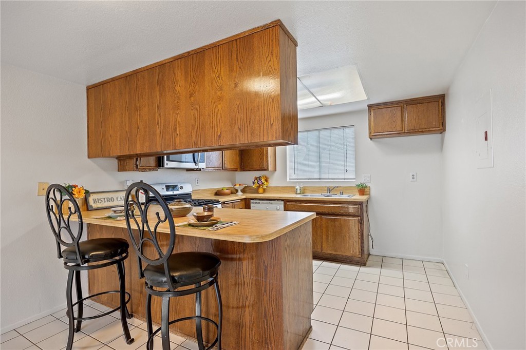 1435 Prospect Avenue, Unit B Placentia, CA 92870 - Photo 3 of 27 a kitchen with a sink a stove and chairs