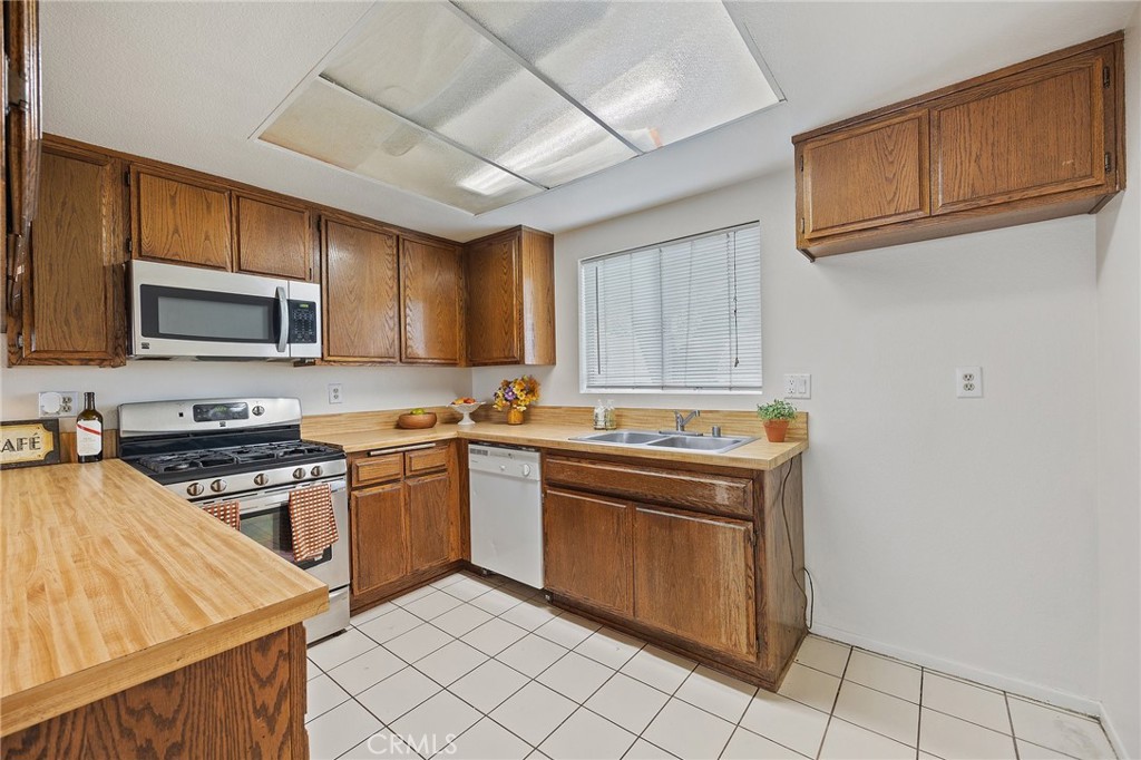 1435 Prospect Avenue, Unit B Placentia, CA 92870 - Photo 4 of 27 a kitchen with stainless steel appliances granite countertop a stove a sink dishwasher and a refrigerator