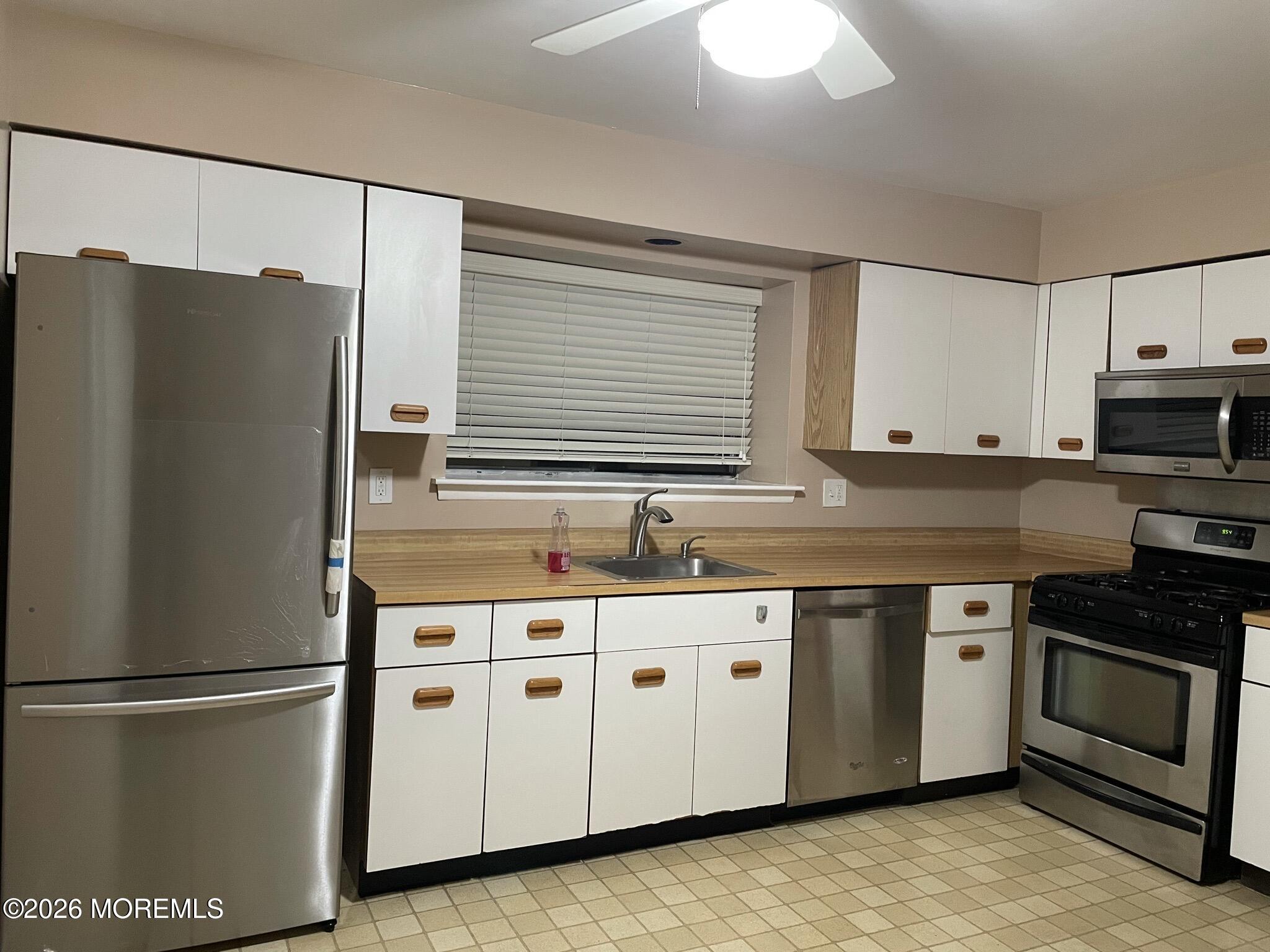 19 Clavendon Court Middletown, NJ 07748 - Photo 7 of 21 a kitchen with stainless steel appliances a refrigerator sink and cabinets