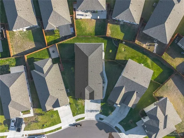 an aerial view of a house with a yard and potted plants