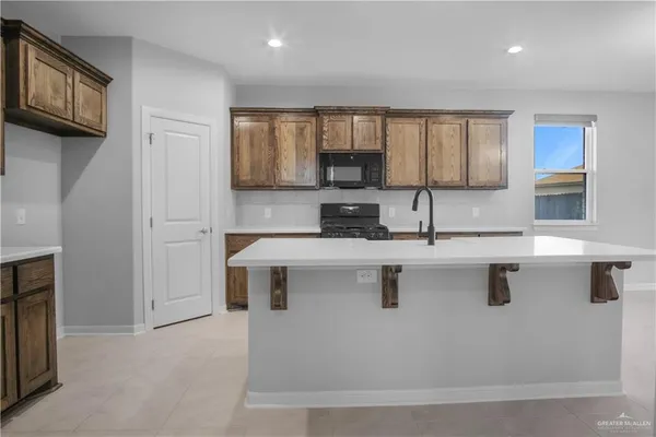 a kitchen with stainless steel appliances granite countertop a sink and a refrigerator