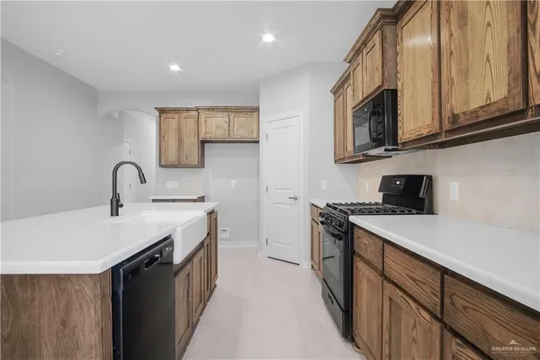 a kitchen with stainless steel appliances granite countertop a sink and stove top oven
