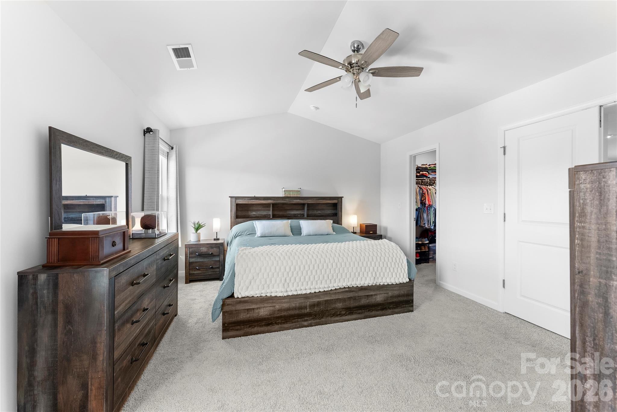 141 Amblers Knl Road Weaverville, NC 28787 - Photo 24 of 48 a bedroom with a bed and a chandelier