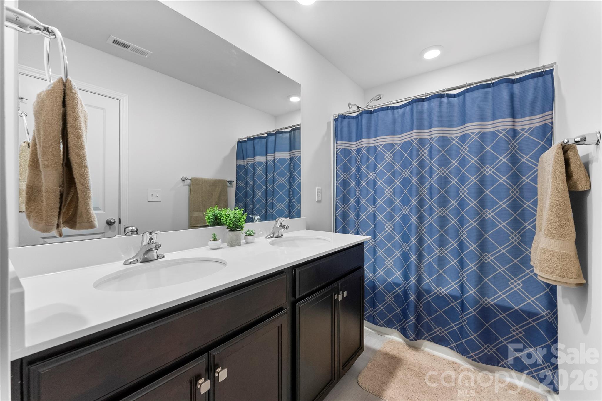 141 Amblers Knl Road Weaverville, NC 28787 - Photo 29 of 48 a bathroom with a sink a mirror and a shower