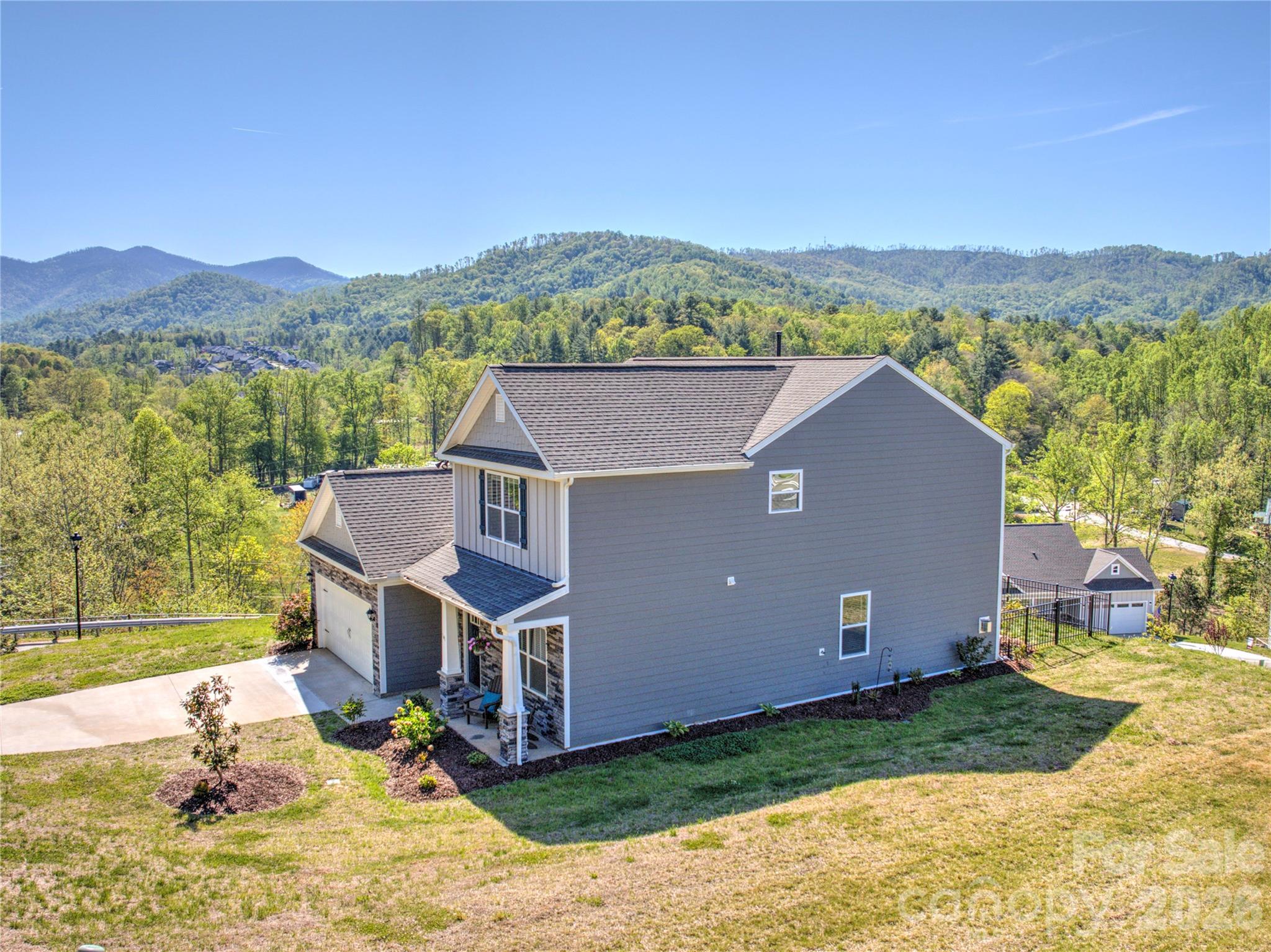 141 Amblers Knl Road Weaverville, NC 28787 - Photo 38 of 48 a view of a house with a mountain in the background