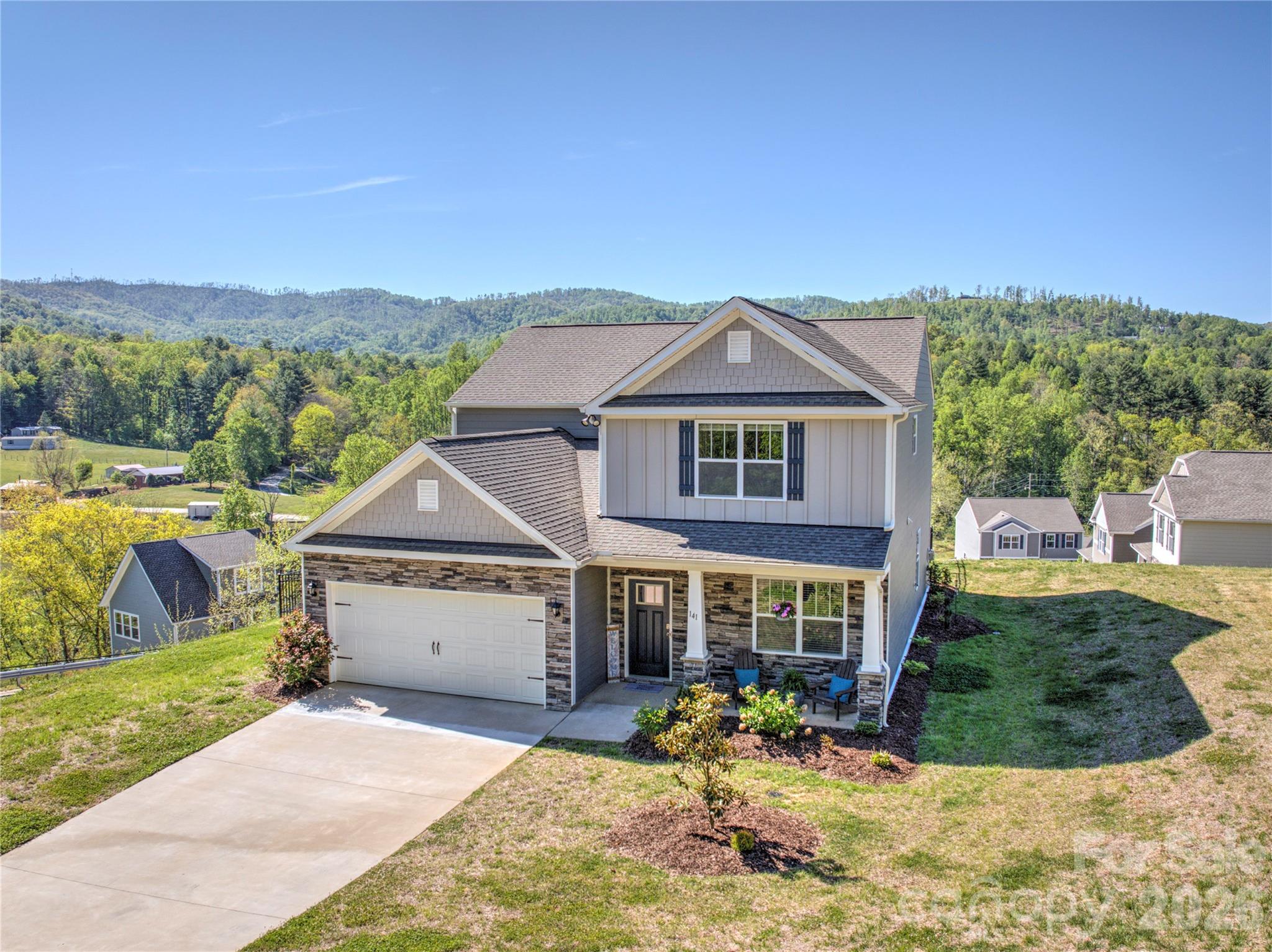 141 Amblers Knl Road Weaverville, NC 28787 - Photo 42 of 48 a front view of a house with a yard outdoor seating and mountain view in back