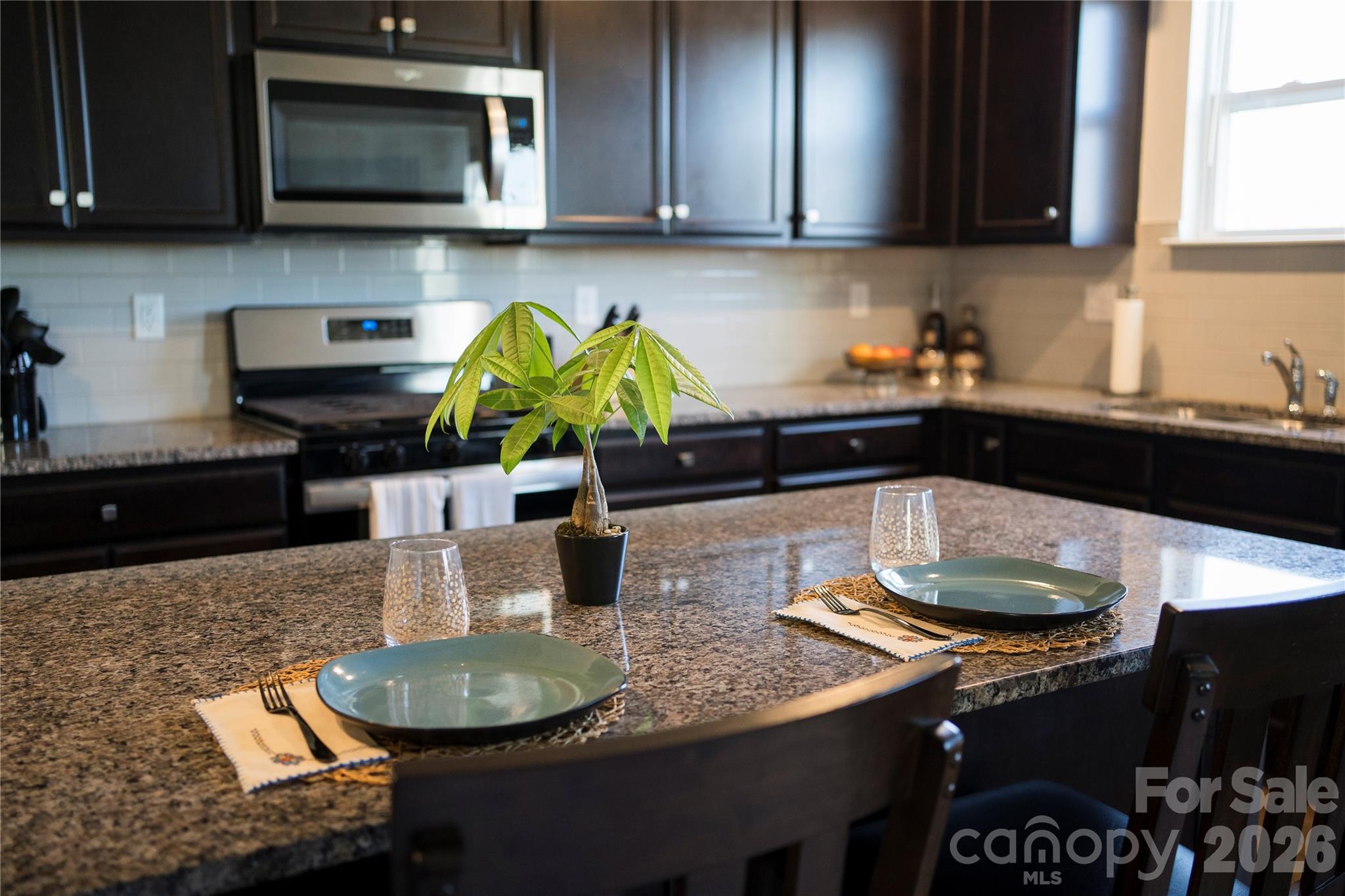 141 Amblers Knl Road Weaverville, NC 28787 - Photo 5 of 48 a kitchen with granite countertop stainless steel appliances a sink a stove a microwave a sink and cabinets