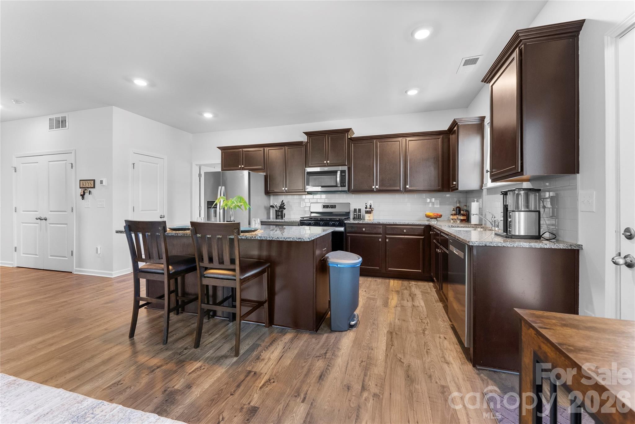 141 Amblers Knl Road Weaverville, NC 28787 - Photo 6 of 48 a kitchen with a table chairs refrigerator and a sink