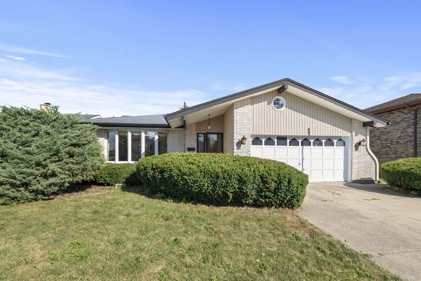 a view of a house with a small yard and plants