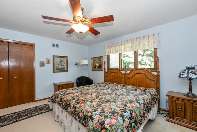 a bedroom with a large bed and a chandelier
