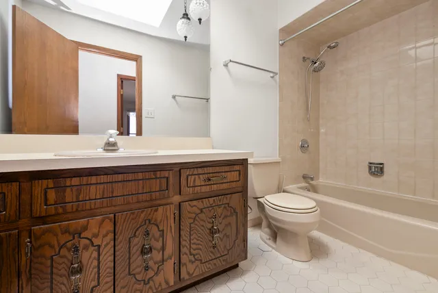 a bathroom with a sink toilet a mirror and shower