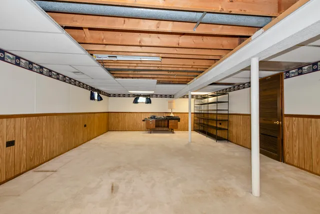 a view of an empty room with wooden ceiling