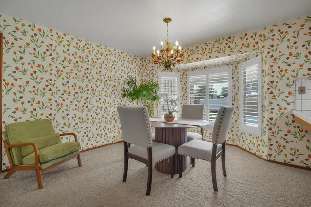 a view of a dining room with furniture and chandelier