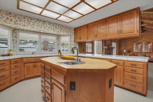 a kitchen with stainless steel appliances granite countertop a sink and cabinets
