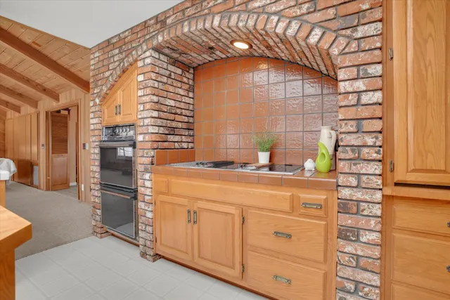 a kitchen with stainless steel appliances a refrigerator and cabinets