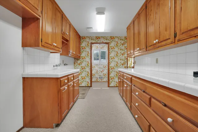a kitchen with stainless steel appliances granite countertop a sink and a refrigerator