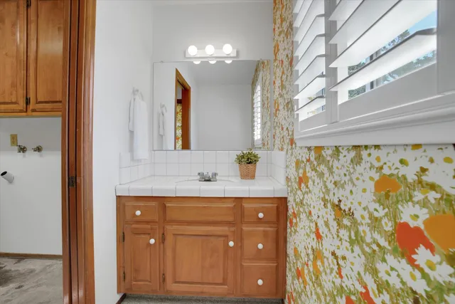 a bathroom with a sink a vanity and a mirror