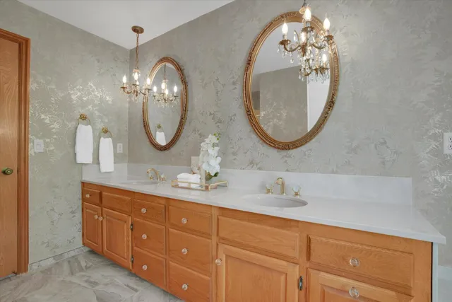 a bathroom with a double vanity sink and a mirror