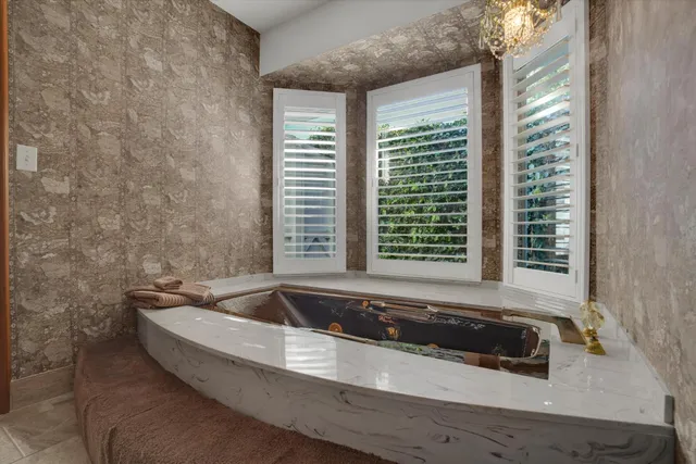 a bath tub sitting in a bathroom next to a window