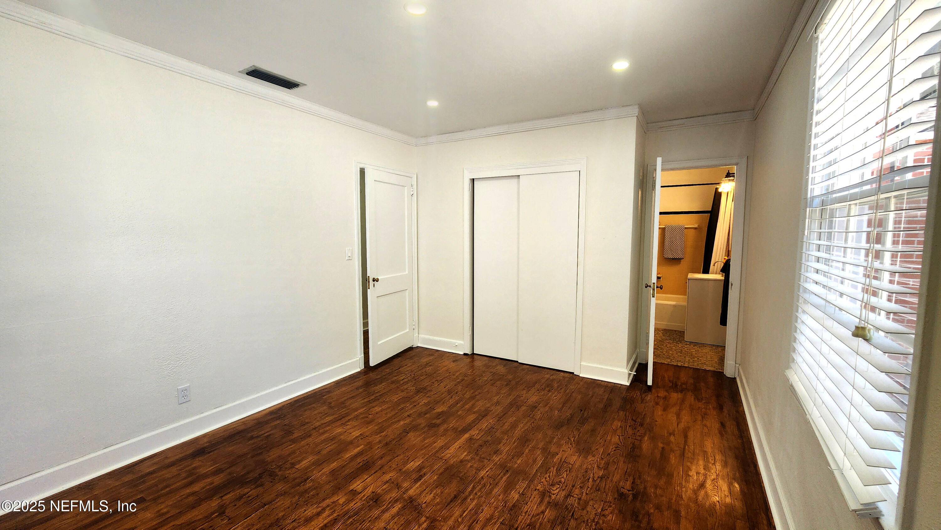 1418 Nicholson Road Jacksonville, FL 32207 - Photo 15 of 35 a view of empty room with wooden floor and fan