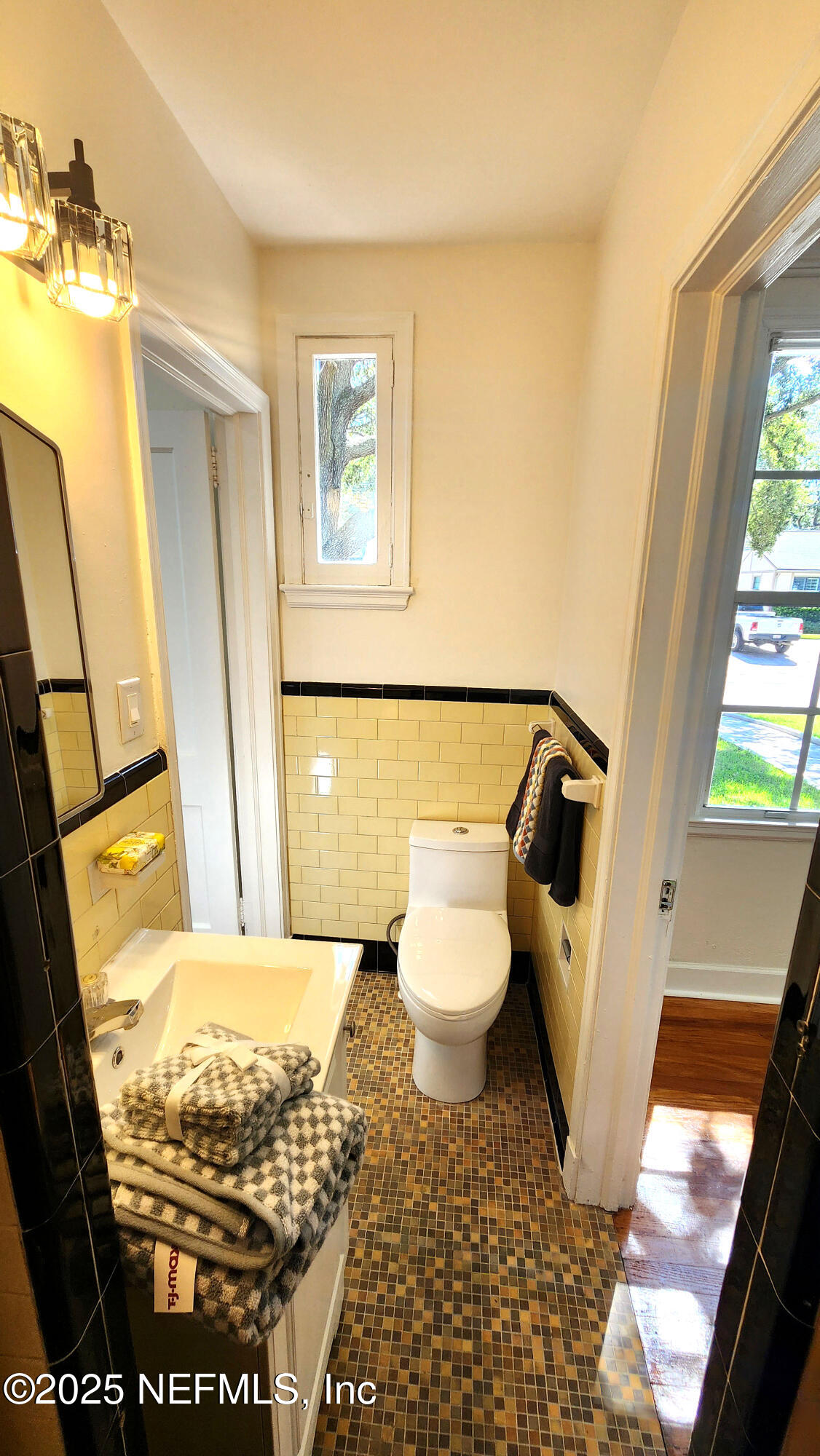 1418 Nicholson Road Jacksonville, FL 32207 - Photo 17 of 35 a bathroom with a toilet and a mirror