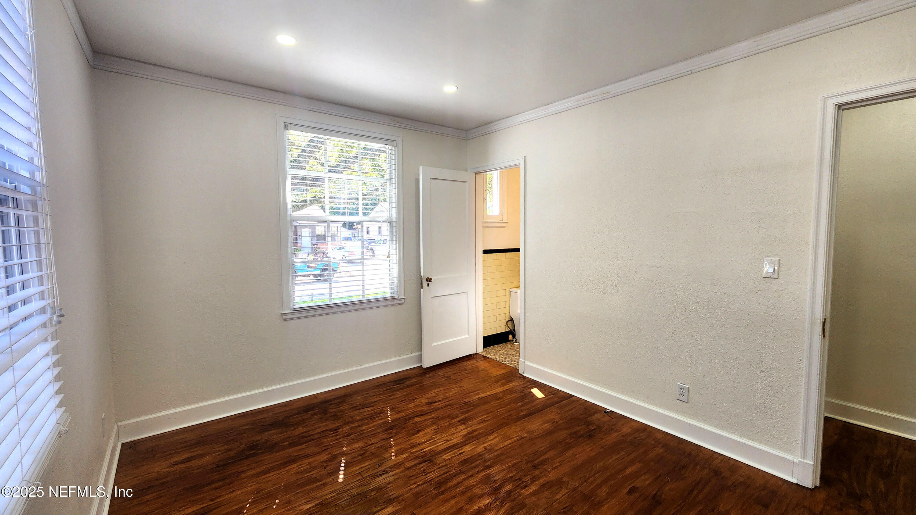 1418 Nicholson Road Jacksonville, FL 32207 - Photo 20 of 35 a view of empty room with wooden floor and fan